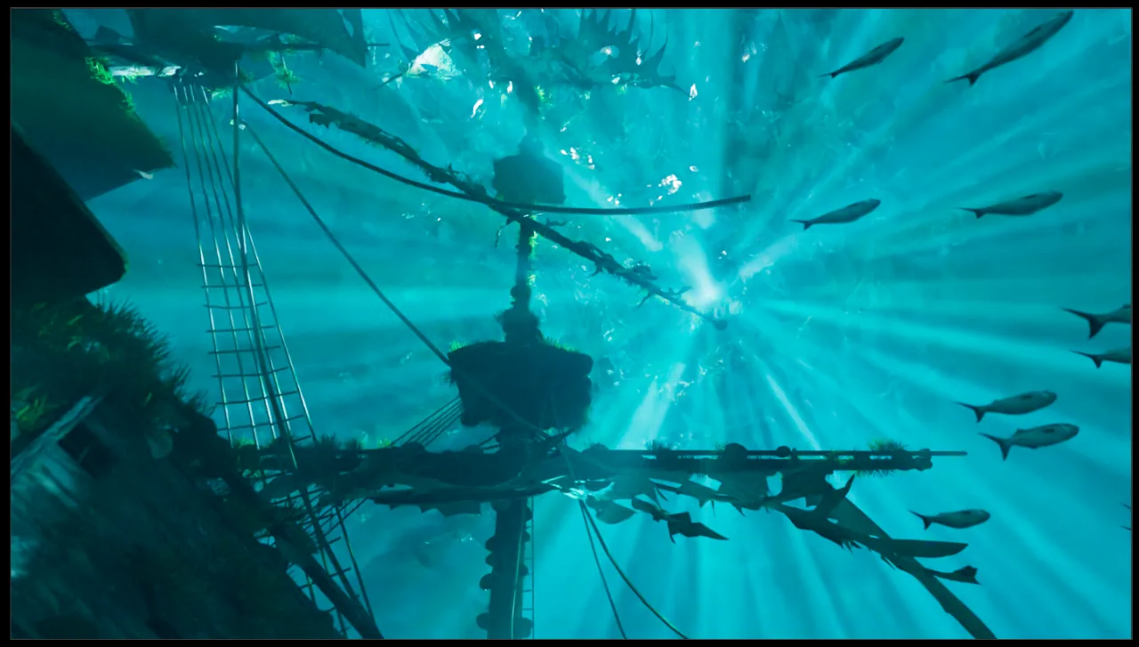 The mast of a sunken ship seen from below, with fish circling in the sunbeams